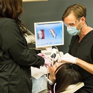 Dr. Hill taking digital scan of patient's tooth