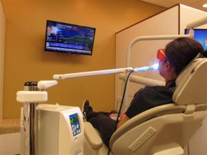 Patient receiving Lumibrite chairside teeth whitening